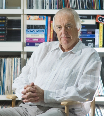 Head shot of Tim Rice sitting in front of a bookcase